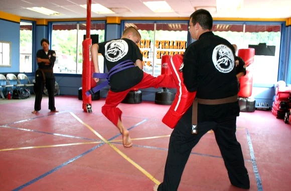 Kicking practice on the heavy bag